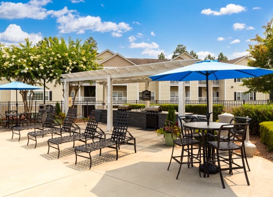 Poolside patio with grills at Abberly Grove Apartment Homes, Raleigh, NC
