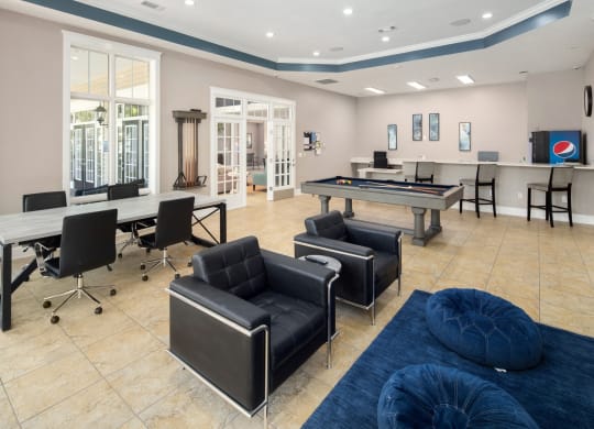 a game room with tables and chairs and a pool table