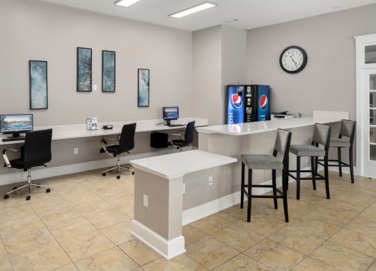 a business center with a desk and chairs and a clock on the wall