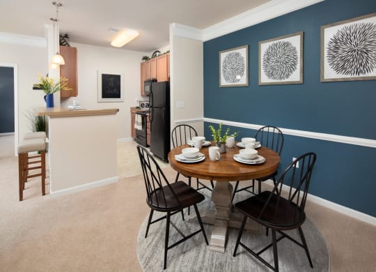 a dining room and kitchen with a table and chairs