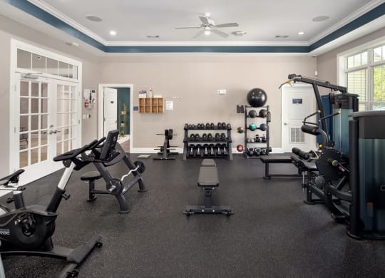 a home gym with exercise equipment and weights