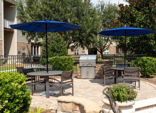 a patio with tables and chairs and umbrellas