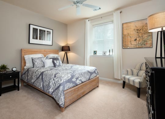 a bedroom with a bed and a ceiling fan