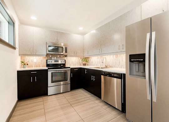 A modern kitchen with stainless steel appliances and wooden cabinets at Altitude Apartment , Tacoma, WA