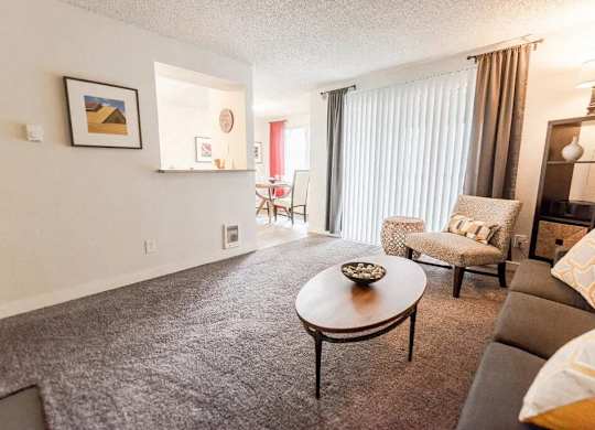 A living room with a grey carpet and a brown coffee table at Altitude Apartment , Washington