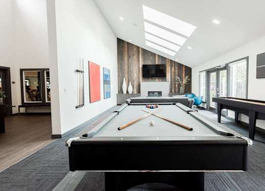 A pool table is in the middle of a room with a TV and a fireplace at Altitude Apartment , Tacoma, 98444