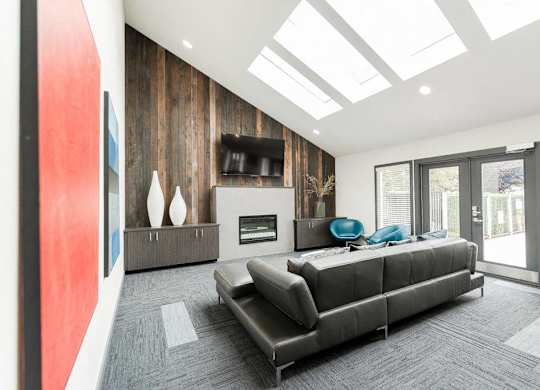 A modern living room with a grey sofa and a fireplace at Altitude Apartment , Tacoma