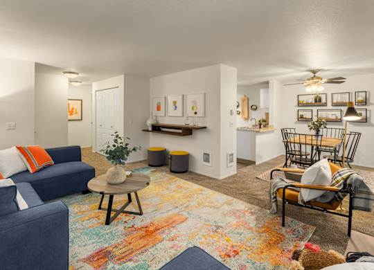 A living room with a blue couch and a rug with a bear on it.