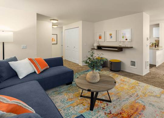 A living room with a blue couch and a coffee table.