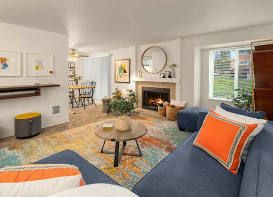 A living room with a fireplace and a blue couch.