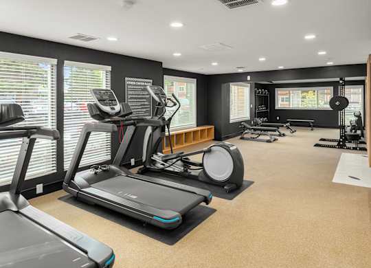 A spacious gym with treadmills, elliptical machines, and other exercise equipment.