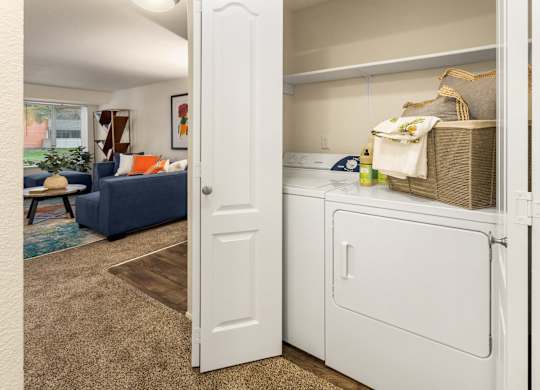 A white refrigerator with a basket on top of it.