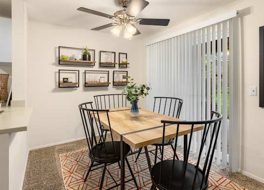 A dining room with a table and chairs.