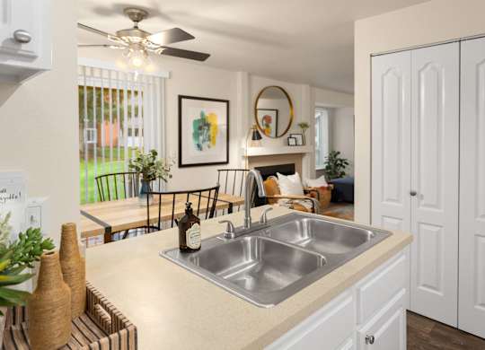 A kitchen with a sink and a fan.