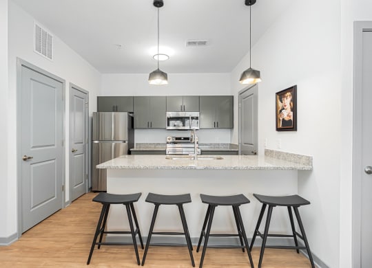 a kitchen with a counter top and three stools
