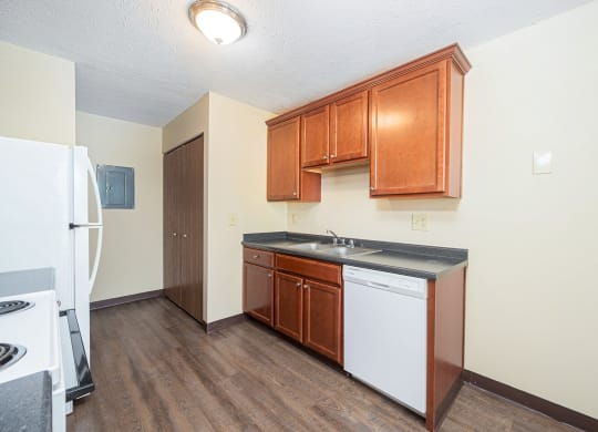 a kitchen with wooden cabinets and a white appliances