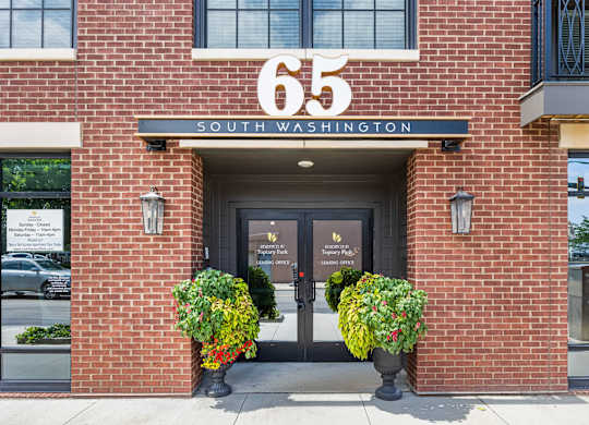 The front of a building with the number 65 and the words South Washington on it.