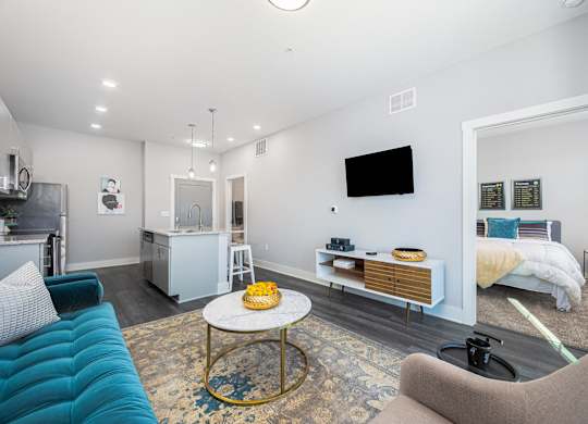 a living room with a blue couch and a table