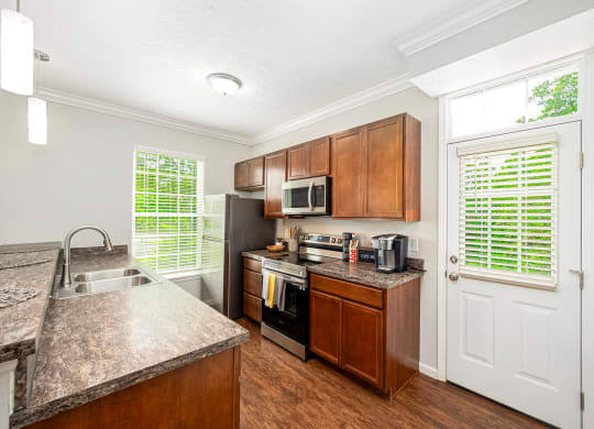 a kitchen with stainless steel appliances and wooden cabinets