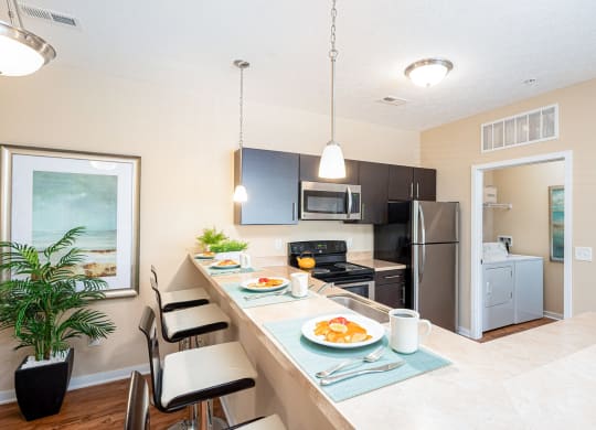 a kitchen with a long counter with plates of food