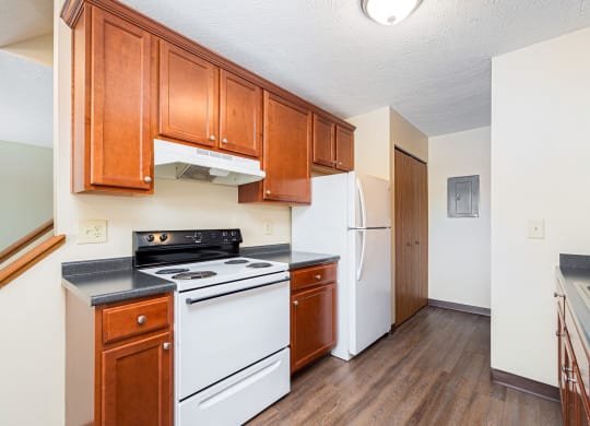 a kitchen with white appliances and wooden cabinets