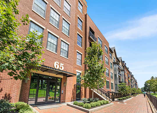 A brick building with the number 65 on it.