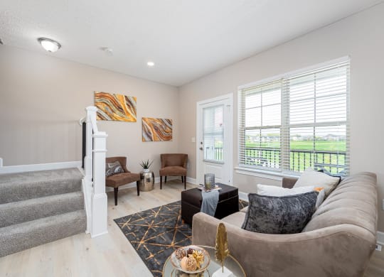 a living room with a staircase and a couch
