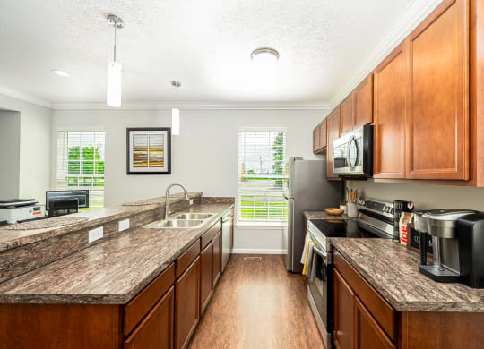 a kitchen with wooden cabinets and granite counter tops