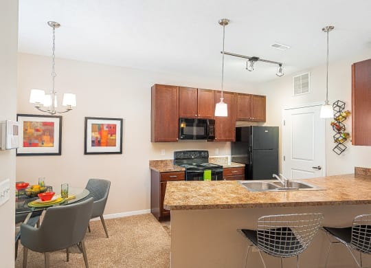 an open kitchen and dining area with a granite counter top