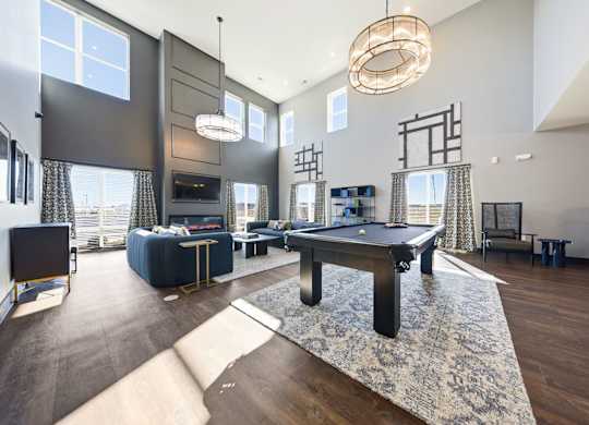 A modern living room with a pool table and a television.