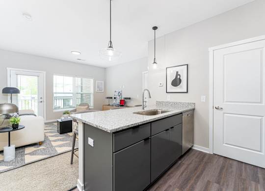 A kitchen with a sink and a counter.