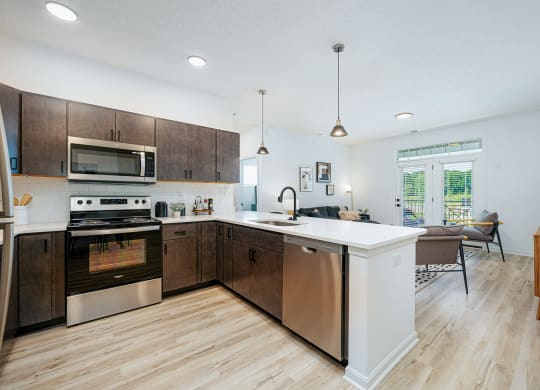a large kitchen with wooden cabinets and stainless steel appliances
