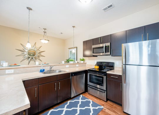 full kitchen with stainless steel appliances at the reserve at walnut creek apartments