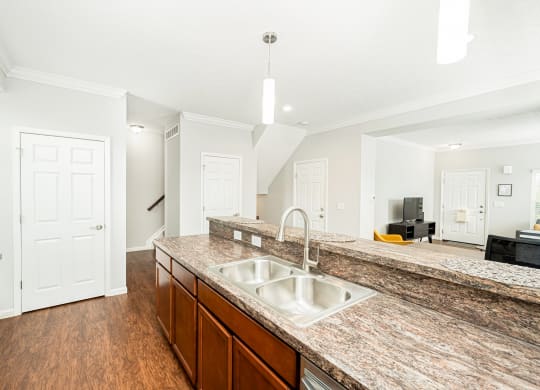 a large kitchen with a sink and a counter top