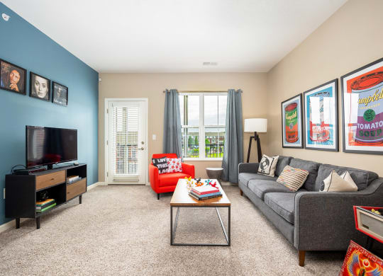 a living room with a couch and a coffee table and a television