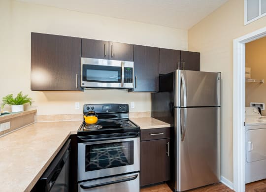 a kitchen with stainless steel appliances and a stainless steel refrigerator