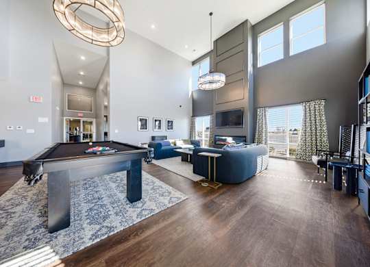 A large room with a pool table and a television.