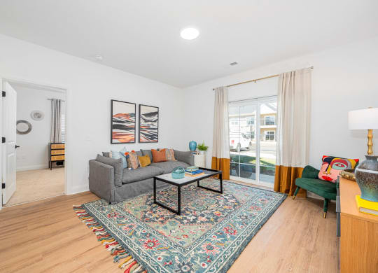 a living room with a couch and a table     and a door