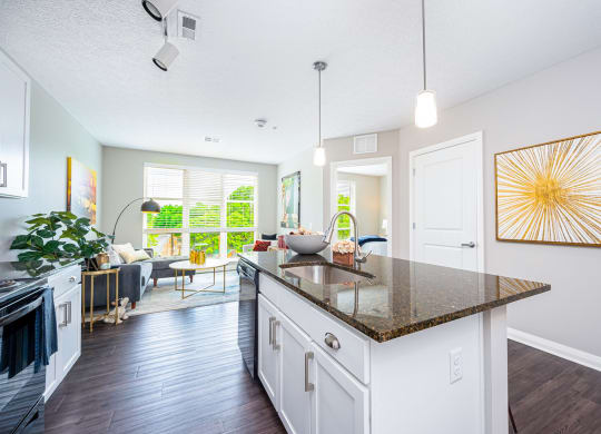 a kitchen with an island and a living room