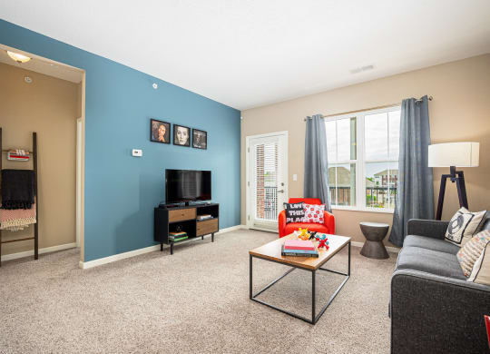 a living room with a blue wall and a couch and a table