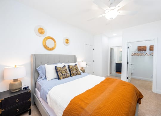 a bedroom with a bed and a ceiling fan
