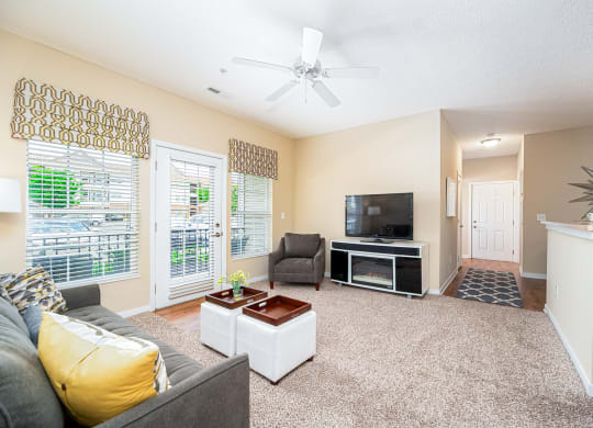a living room with a couch and a ceiling fan