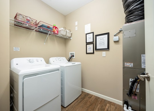 a washer and dryer in a laundry room with a door to a closet