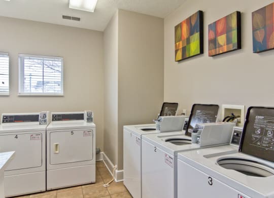 washers and dryers in the laundry room of an apartment building