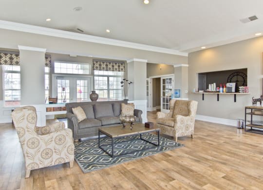 a living room with couches and chairs and a tv