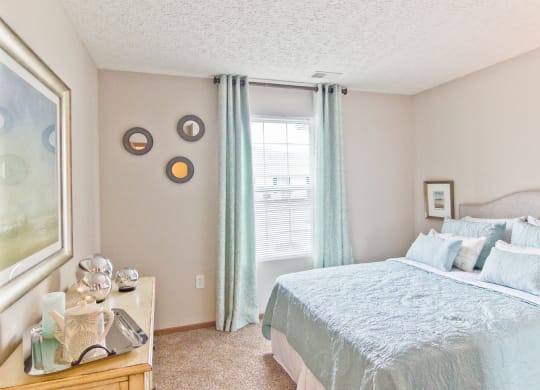 a bedroom with a large bed and a window