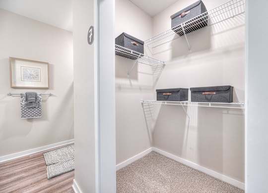 A room with a white wall and a picture frame on it.