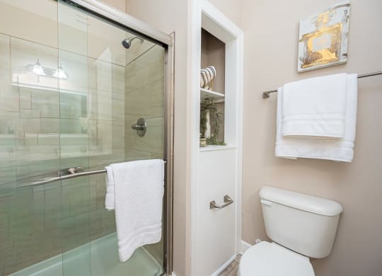 a bathroom with a toilet and a glass shower