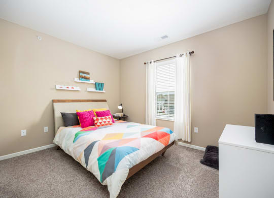 a bedroom with a bed and a window