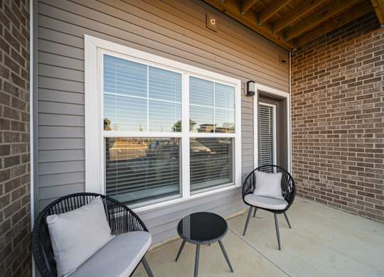 A patio with a chair and a table.